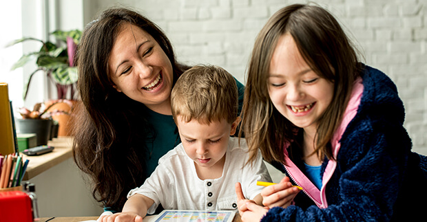 Family gathered around a tablet