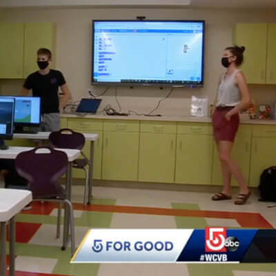 students teaching coding