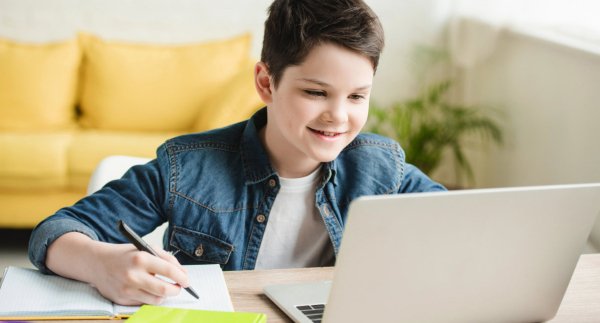 Student writing while in an online class