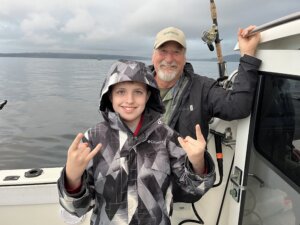 Connor and dad on a fishing boat