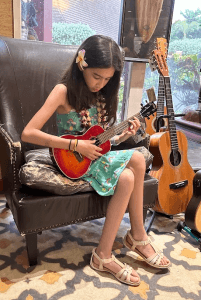 Emma playing ukulele